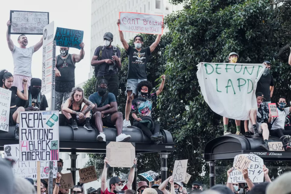 A group of protestors support Black Lives Matter and call for police reforms while gathered on top of a bus stop in Los Angeles.